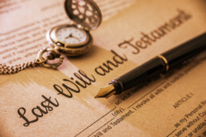 Vintage / retro style with a long shadow : Fountain pen a pocket watch on a last will and testament. A form is printed on a mulberry paper and waiting to be filled and signed by testator / testatrix.