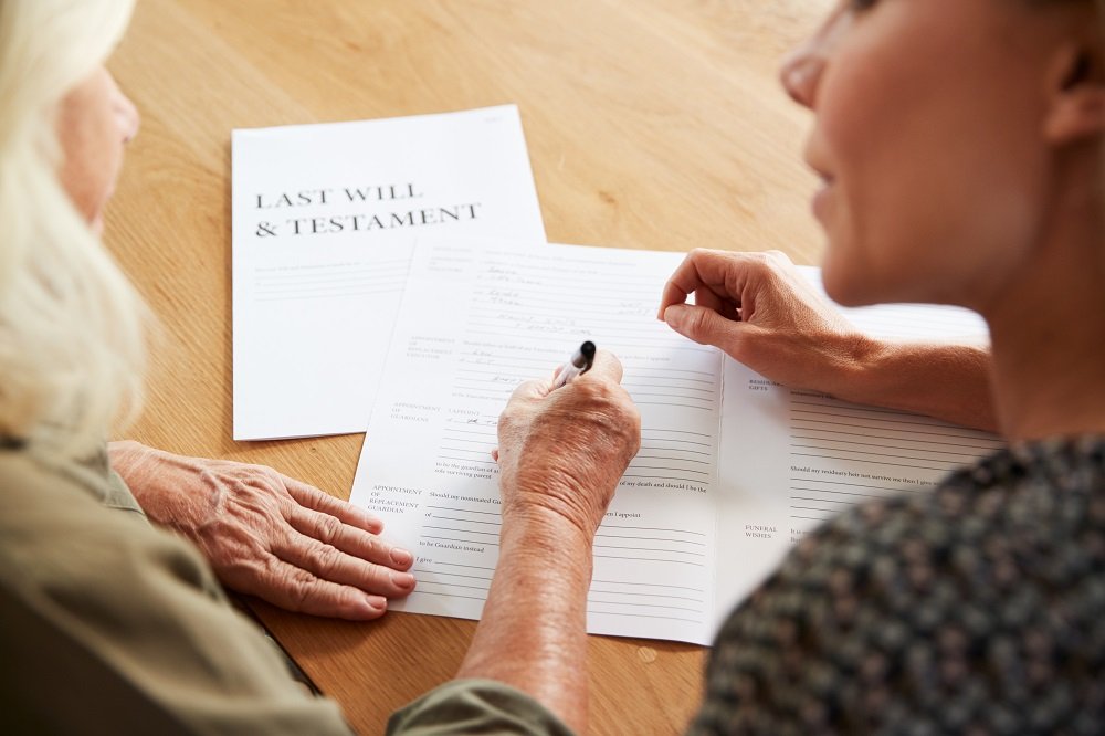 Senior woman writing her last will and testament.