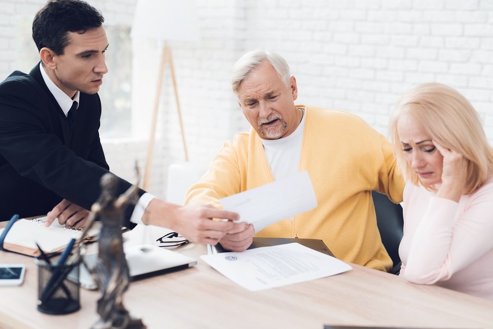 Couple consulting real estate lawyer regarding the issues on trusts.