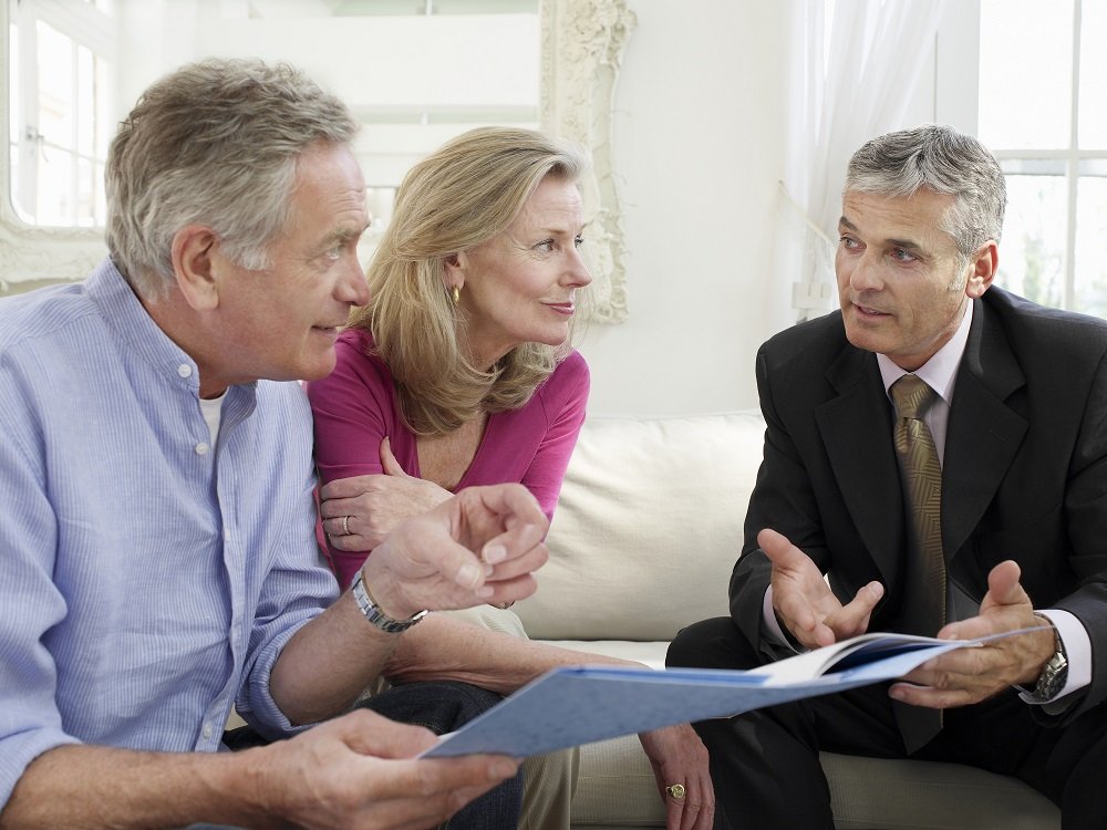 Couple consulting real estate lawyer regarding their trusts.