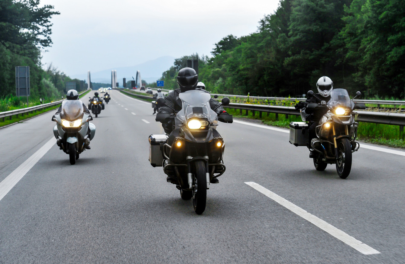 Motorcycle riders convoy pass through the highway.