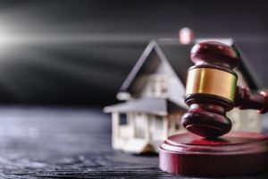 A gavel and a home to represent a property division case in Sun City, AZ.