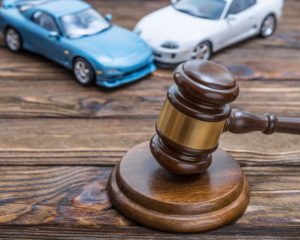 Car accident lawyer concept with gavel at the center.