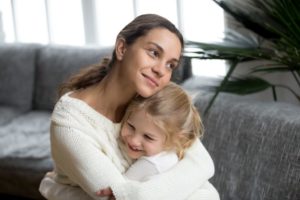 Happy mother is hugging her cute daughter.