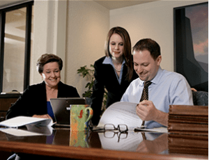 A Peoria AZ real estate lawyer meets with clients in her office.