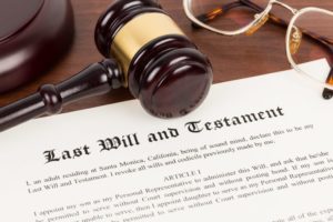 Last will and testament with gavel on top.