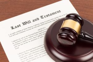 last will and testament with wooden gavel on top