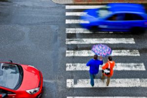 Pedestrian crossing while cars are passing in Arizona.