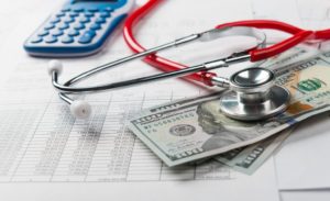 Image of doctor's stethoscope and cash from medical malpractice lawsuit