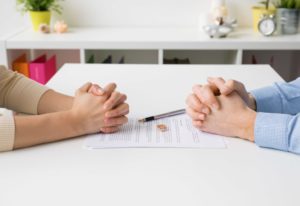 Couple signing their divorce papers.