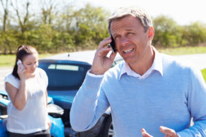 Partially at fault driver calling the police to report accident in Arizona.