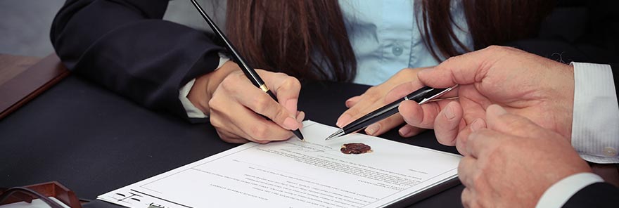 A wills and trusts lawyer guiding his client through a document.