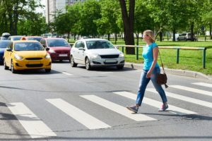A woman crossing a pedestrian lane in Arizona.