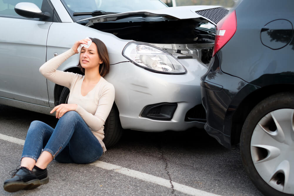 Woman suffering whiplash from a rear end collision.