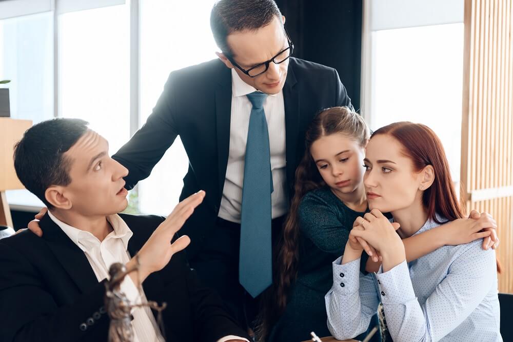 Family in lawyers office discussing child custody.