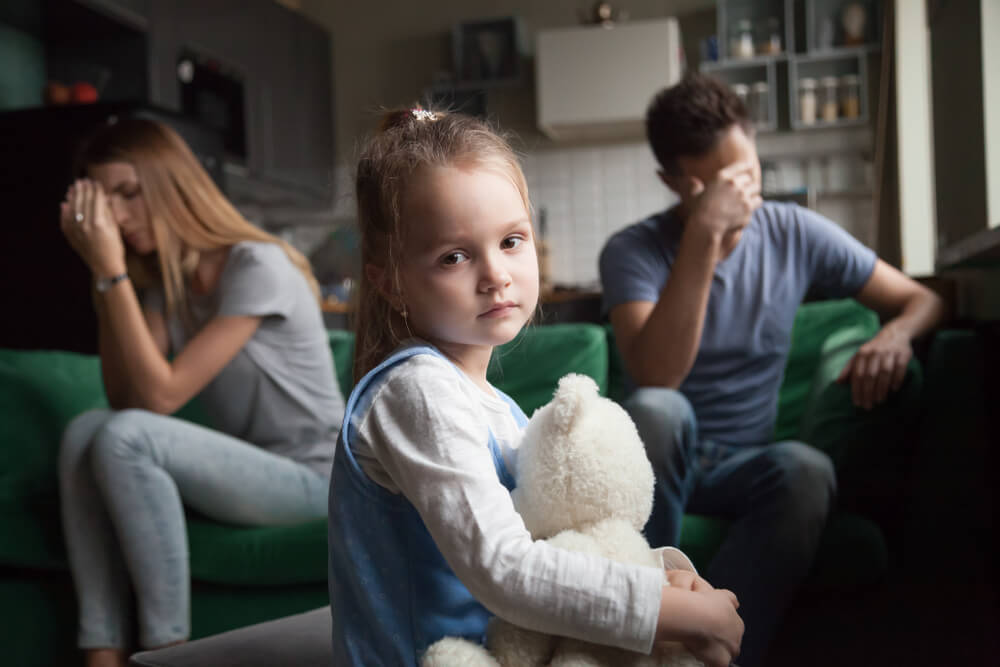 Sad little girl worried over her parents fight.