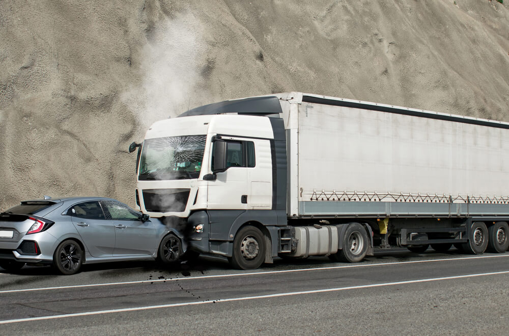 Car vs truck collision on the road.