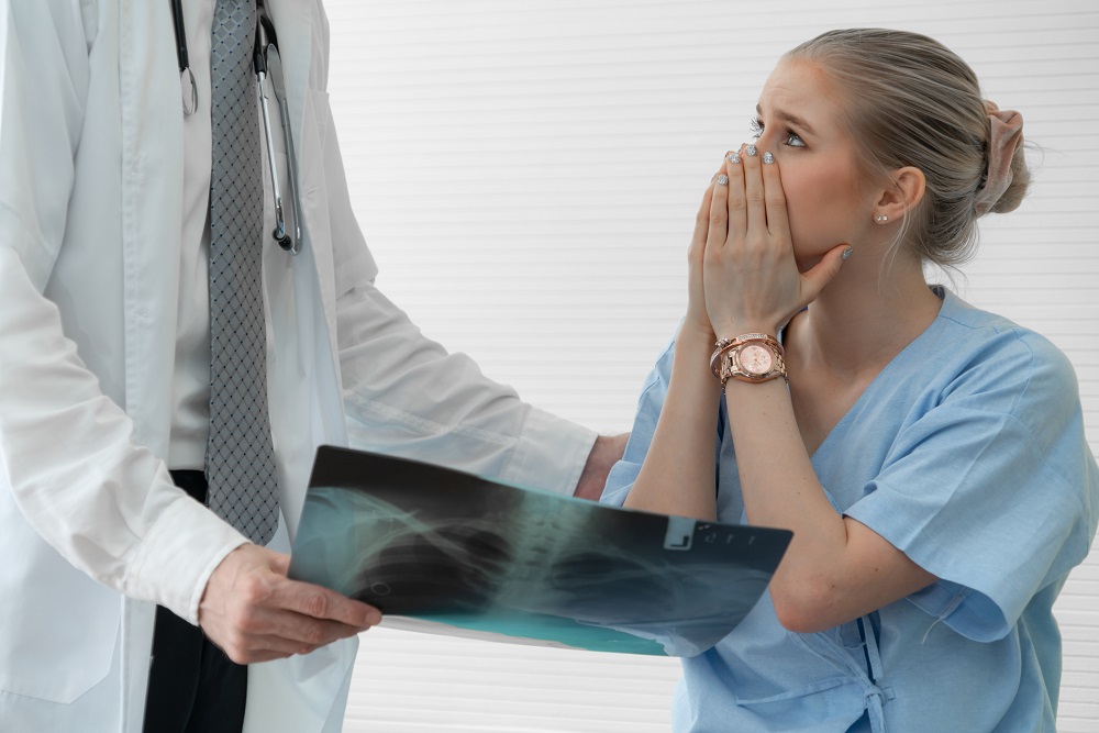 Shocked woman over xrays result given by the doctor.