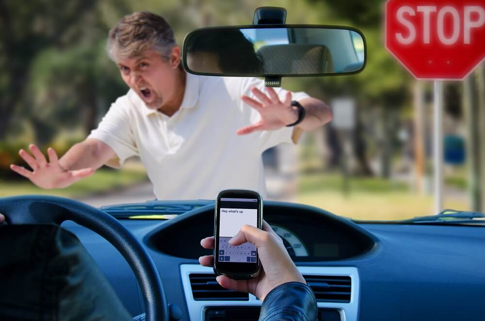 Male pedestrian crossing almost got hit by a distracted driver.