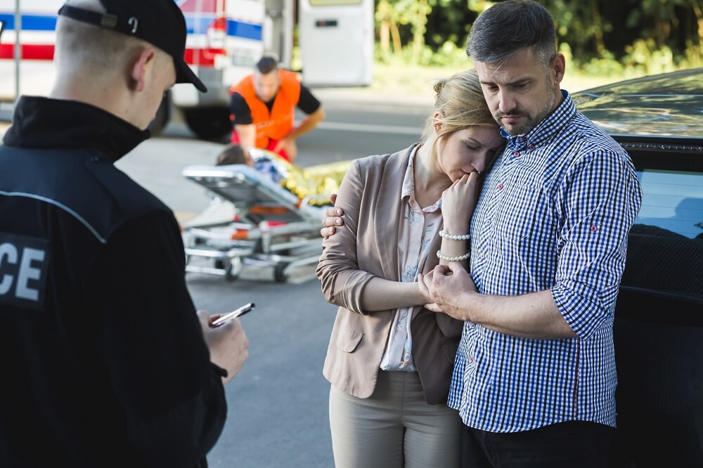 Sad couple interviewed by police in accident lead to wrongful death of another driver.