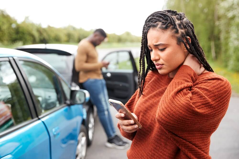 Female driver suffering neck injuries from car accident.