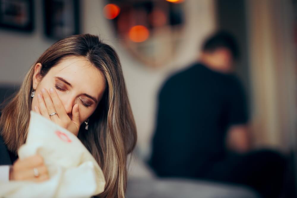 Wife crying on her husband on the polo with lipstick proof of adultery.