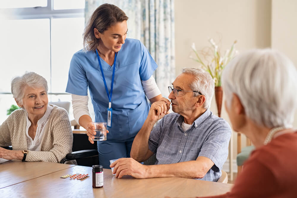 Seniors in the nursing home taking care by the nurses.