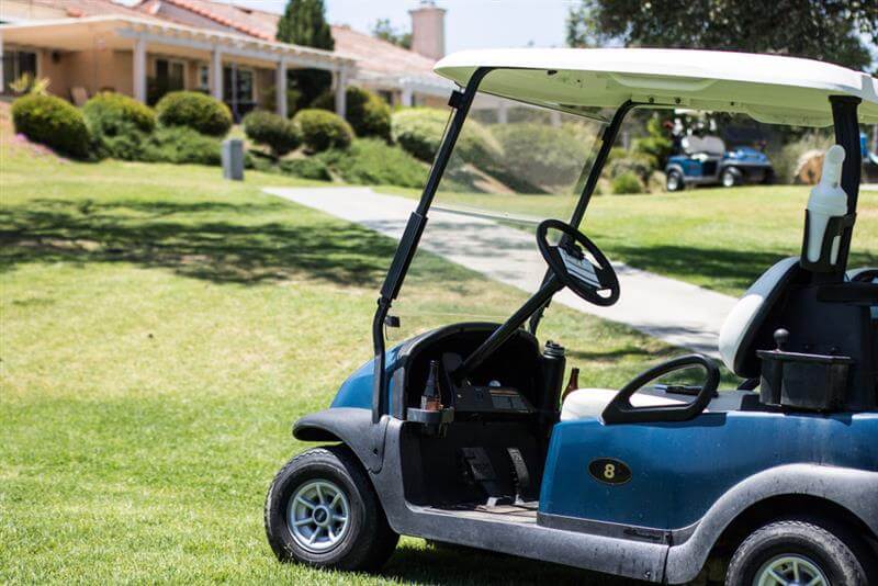 Golf cart parked outside the house.