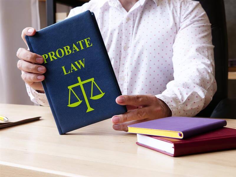 Lawyer holding a probate law book.