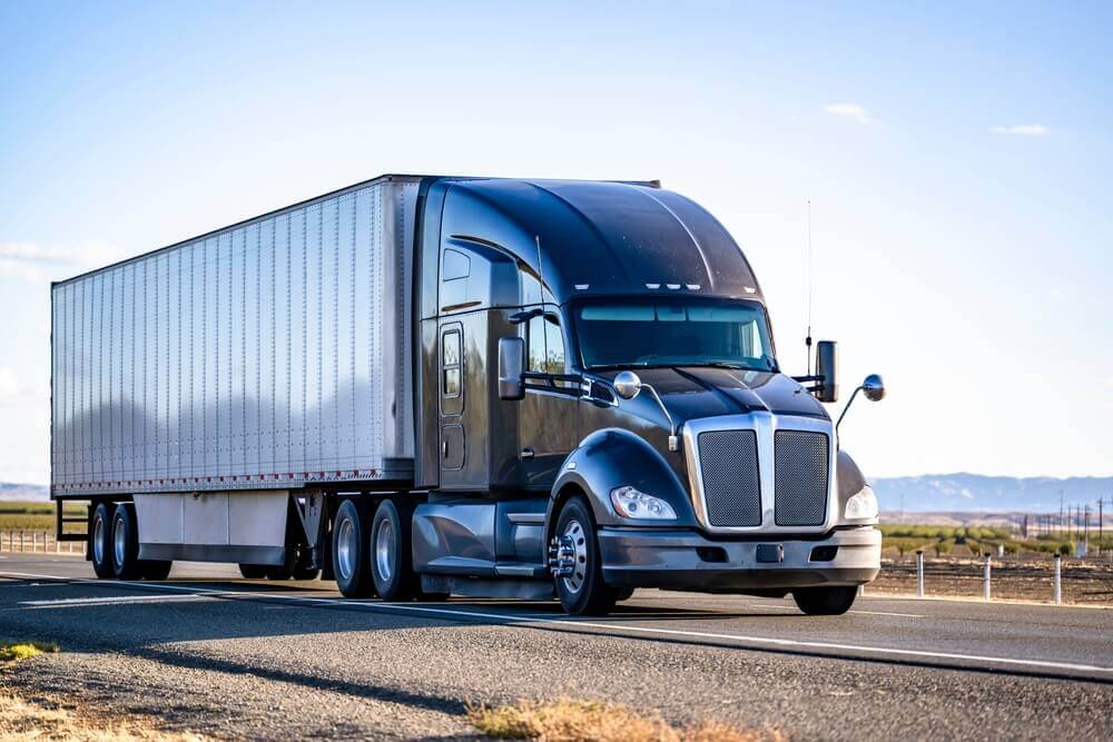 Similar truck like amazon delivery passing highway.