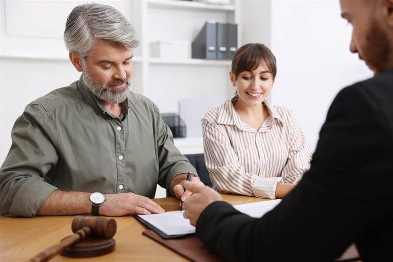 Senior man signing document for trust.