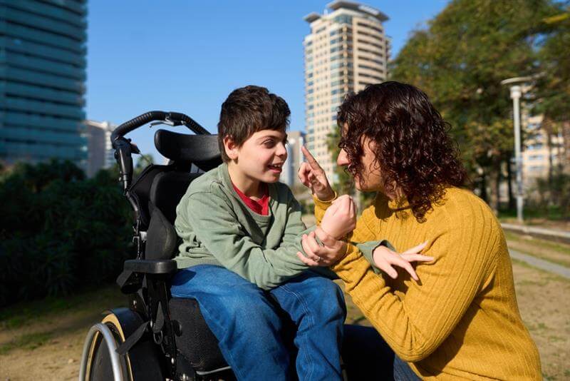Mother and son strolling at the park.