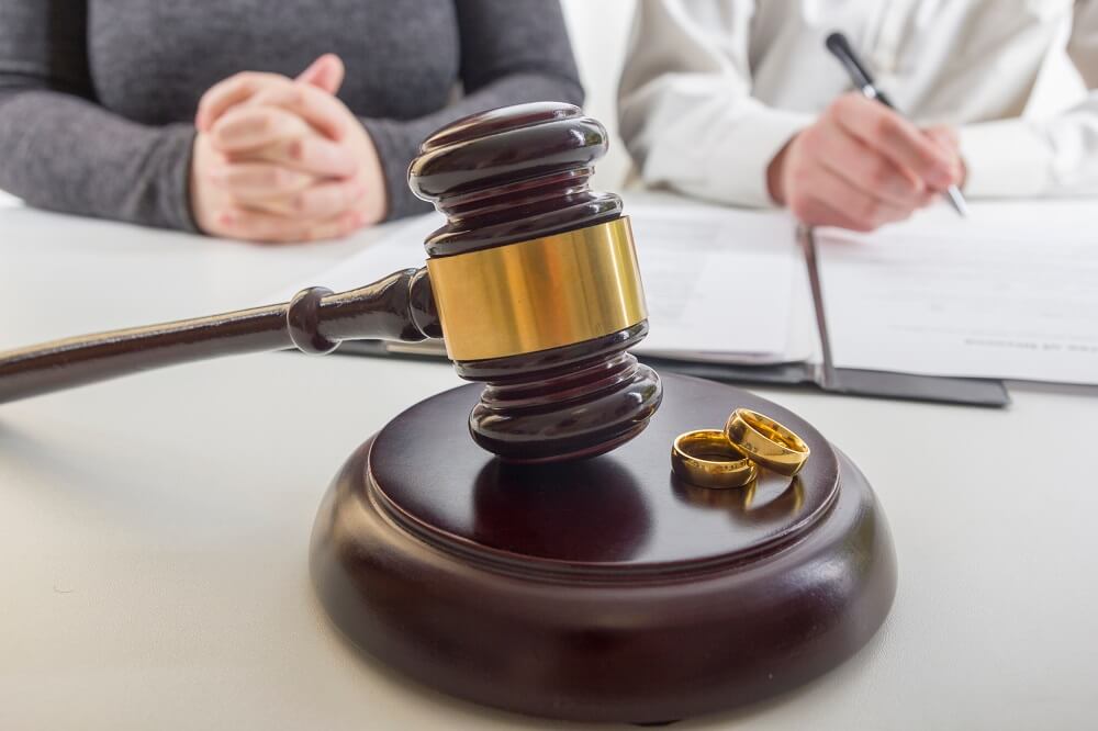 Ex-couple wedding rings in the table, divorce concept.
