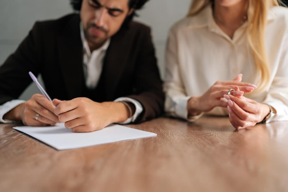 Ex-couple signing divorce documents